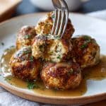 Crispy turkey balls with gravy on plate